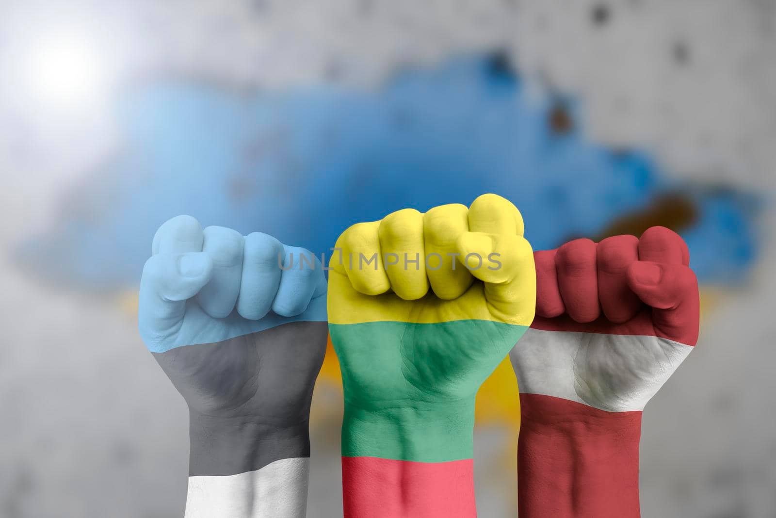 The Baltic countries support Ukraine. Humanitarian aid to Ukraine. The fist is painted in the colors of the flag of Lithuania, Latvia, Estonia against the background of the Ukrainian flag. by SERSOL