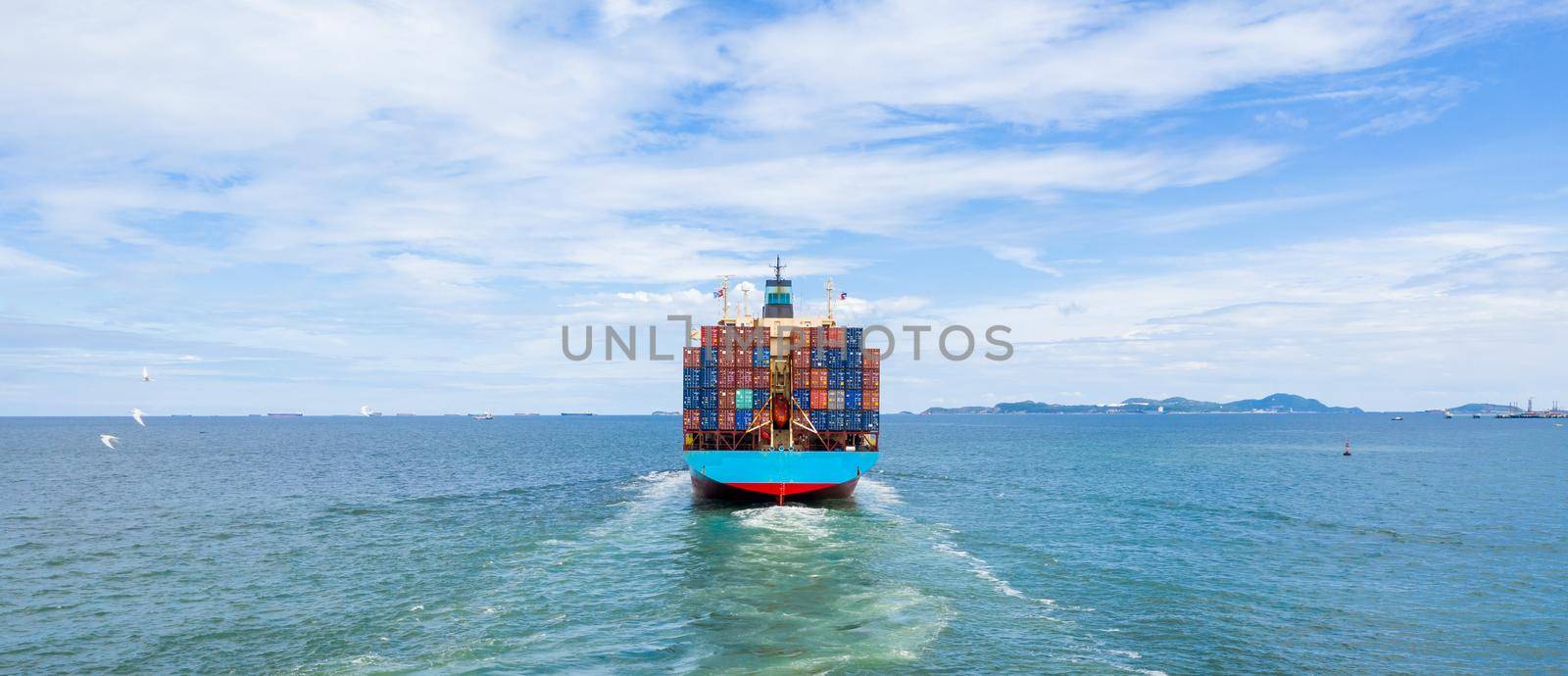Container ship leaving the industrial seaport, Global business Import export, Company business logistic and transportation international by container cargo freight ship in the open sea.