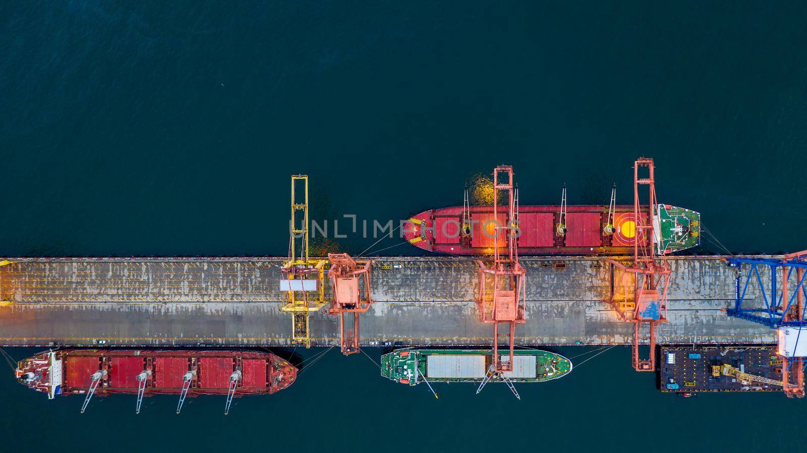 Aerial view bulk carrier dock, Global business import export logistic and transportation company, Commercial dock container cargo vessel freight shipping worldwide.