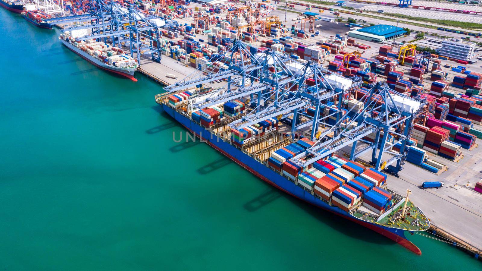 Aerial view container ship at commercial dock, Company import export  global business trade logistic and transportation by container cargo ship boat, Freight shipping maritime sea port terminal.