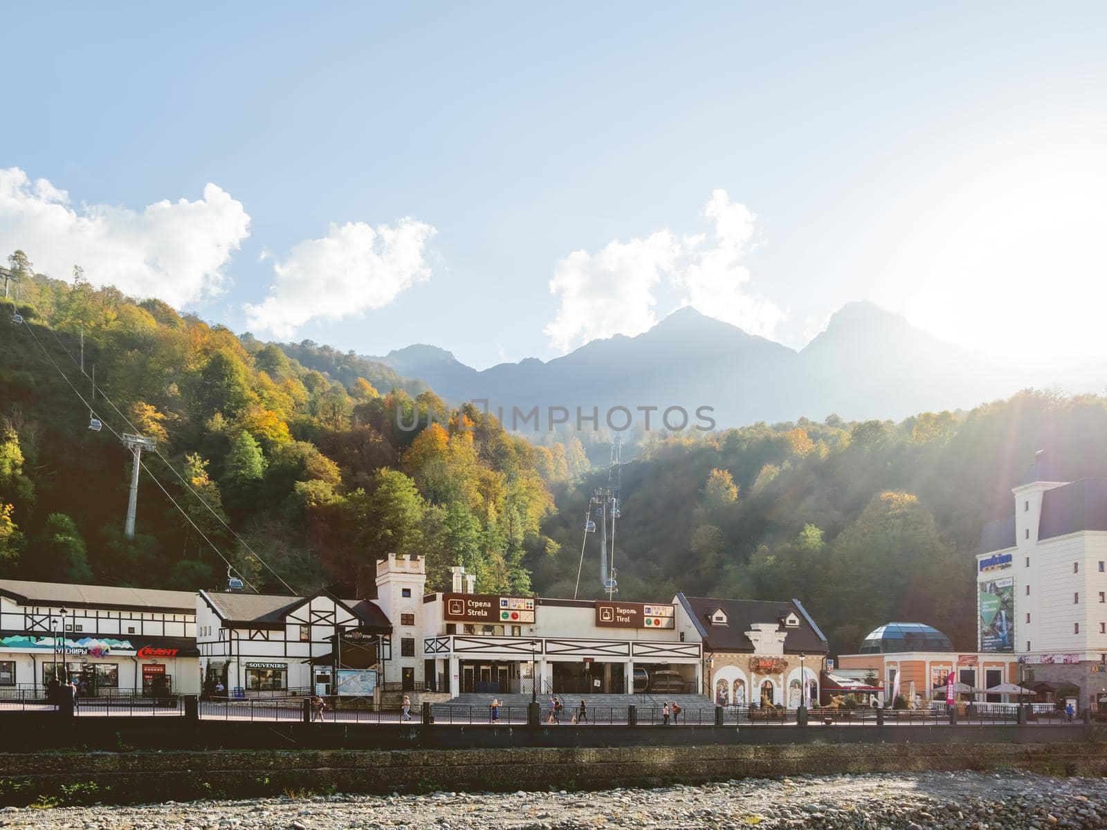 SOCHI, RUSSIA - October 13, 2018. Mzymta river embankment in Rosa Dolina. Famous Rosa Khutor Alpine Ski Resort near Sochi. Tirol and Strela cable road stations.