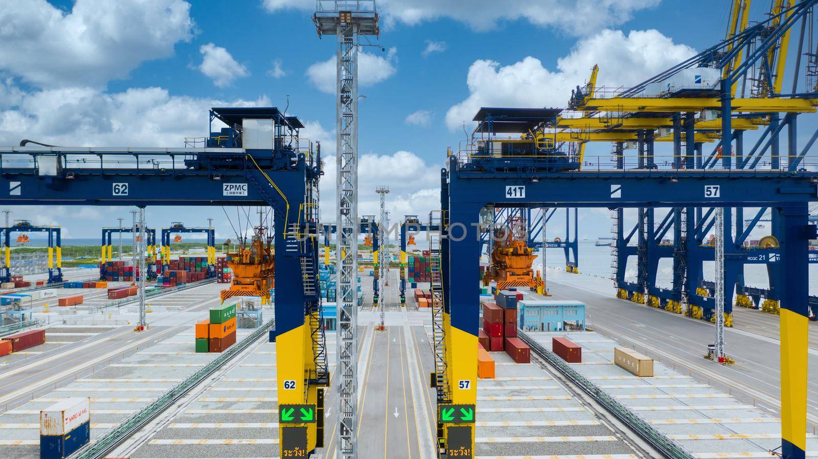 Industrial container yard with crane for business logistic import export, Crane loading cargo container to container ship in the international terminal yard container depot sea port freight shipping. by AvigatoR