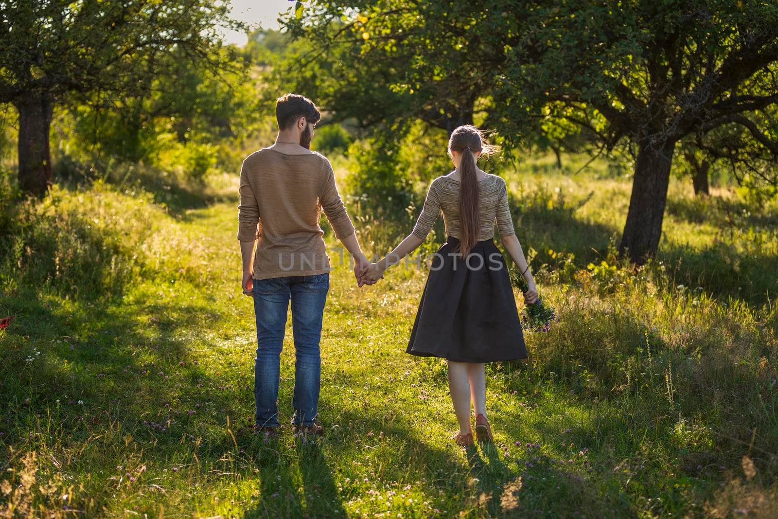 happy young couple walking in nature