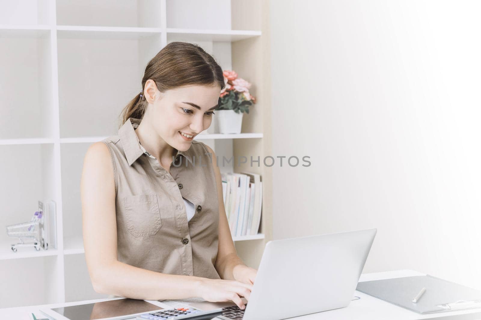 Business woman office girl enjoy working on desk with laptop smiling