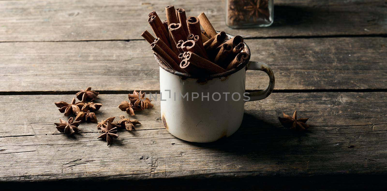 dry brown cinnamon sticks in a metal old mug, culinary spice