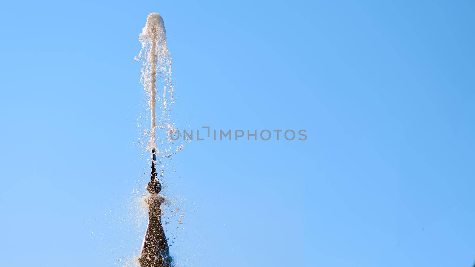 Fountain with shining clear liquid on a blue sky background by jovani68