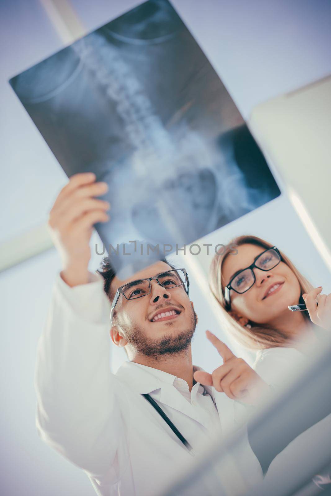 two orthopedic doctors looking at the x-ray of the patient .photo with copy space