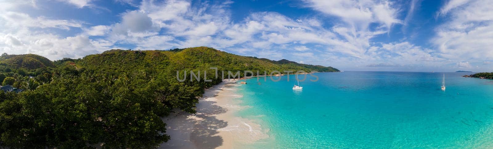 Praslin Seychelles tropical island with withe beaches and palm trees, Anse Lazio beach,Palm tree stands over deserted tropical island dream beach in Anse Lazio, Seychelles.