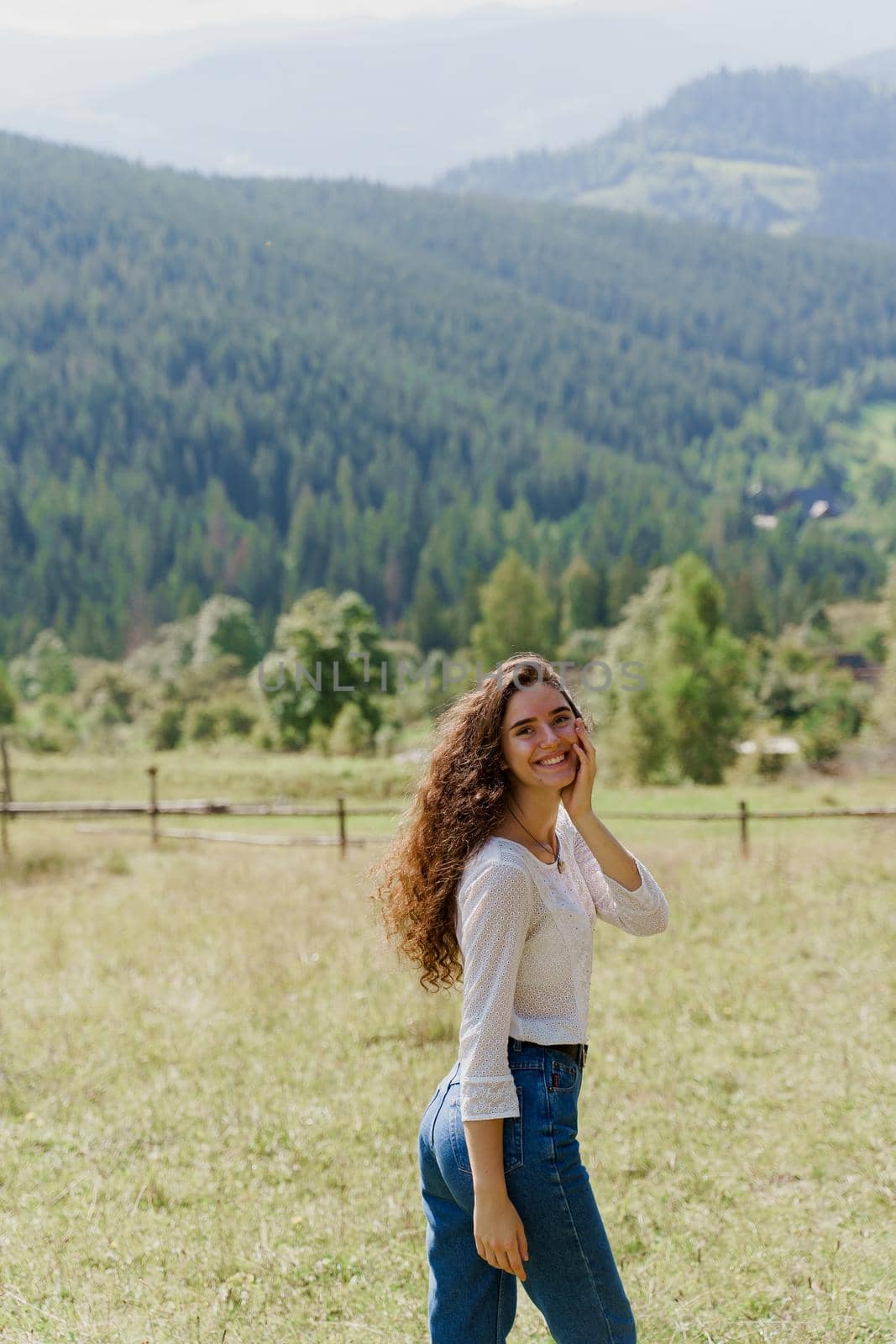 Tourism travelling in Ukraine. Girl enjoying the mountain hills view. Feeling freedom in Karpathian mountains.