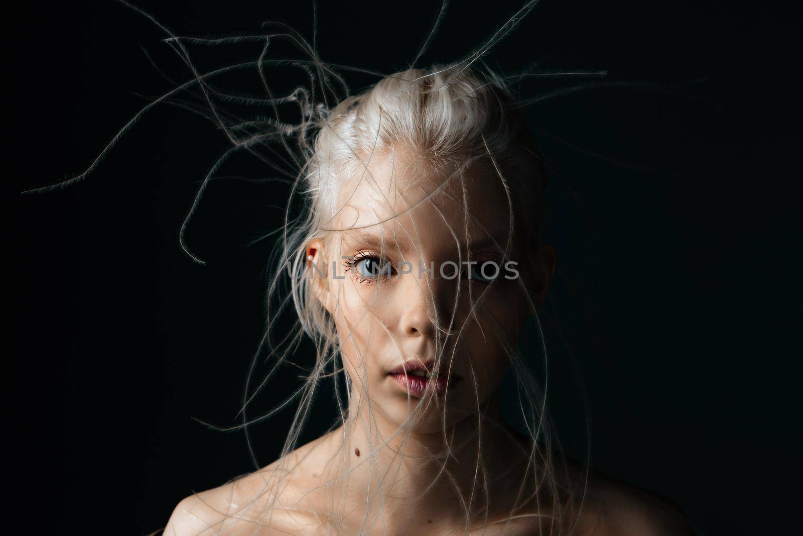 Portrait of a girl with lively curly hair. A young gorgon jellyfish from mythology. Art object