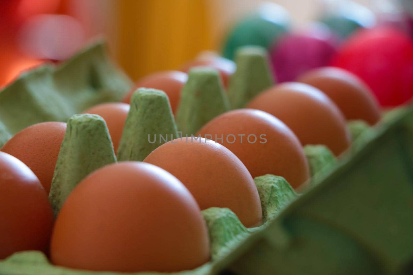 Cardboard package with homemade yellow delicious eggs. Out of focus, blurred