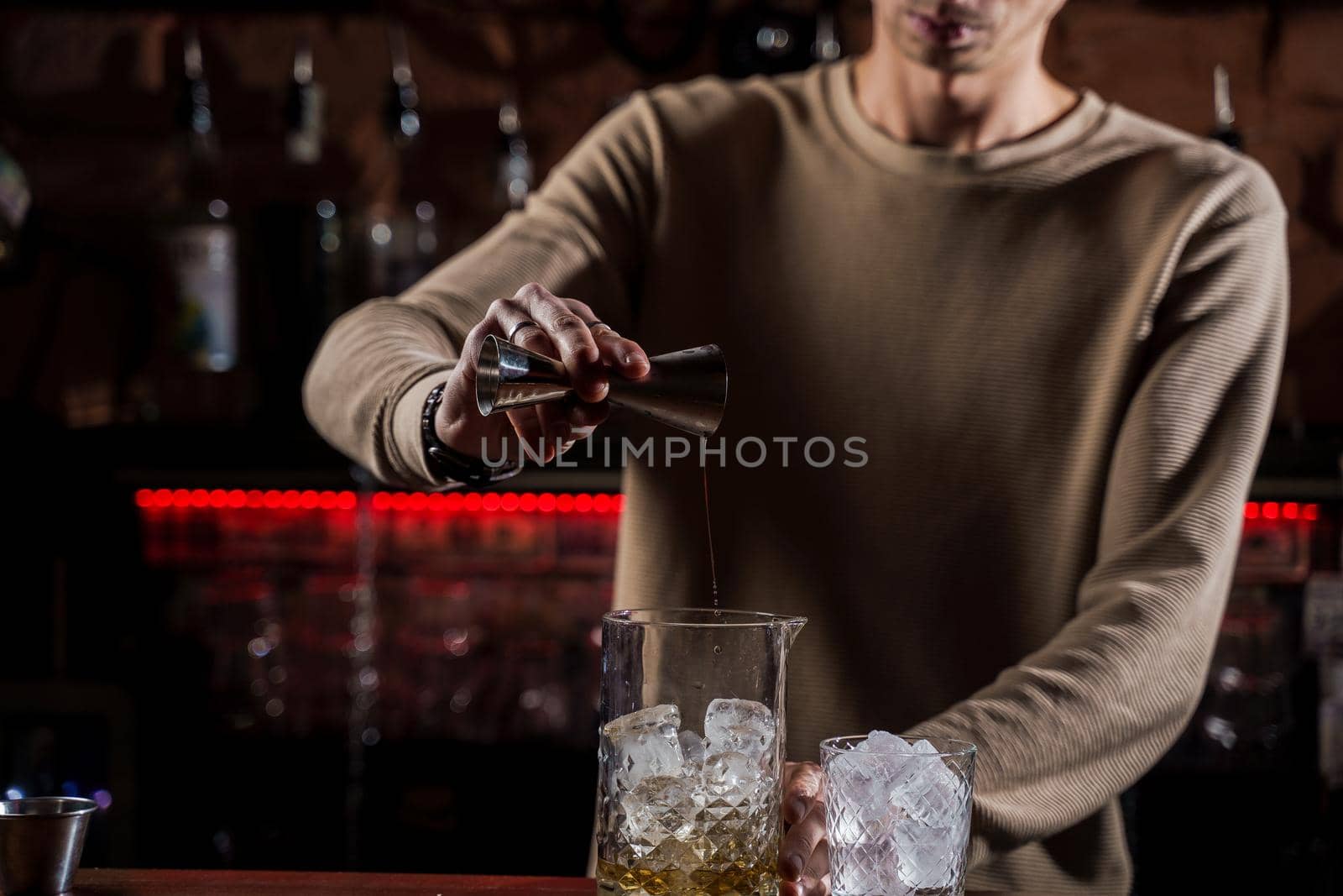 Barman make alcohol cocktail at bar counter. Barman making Jungle Juice coctail in bar
