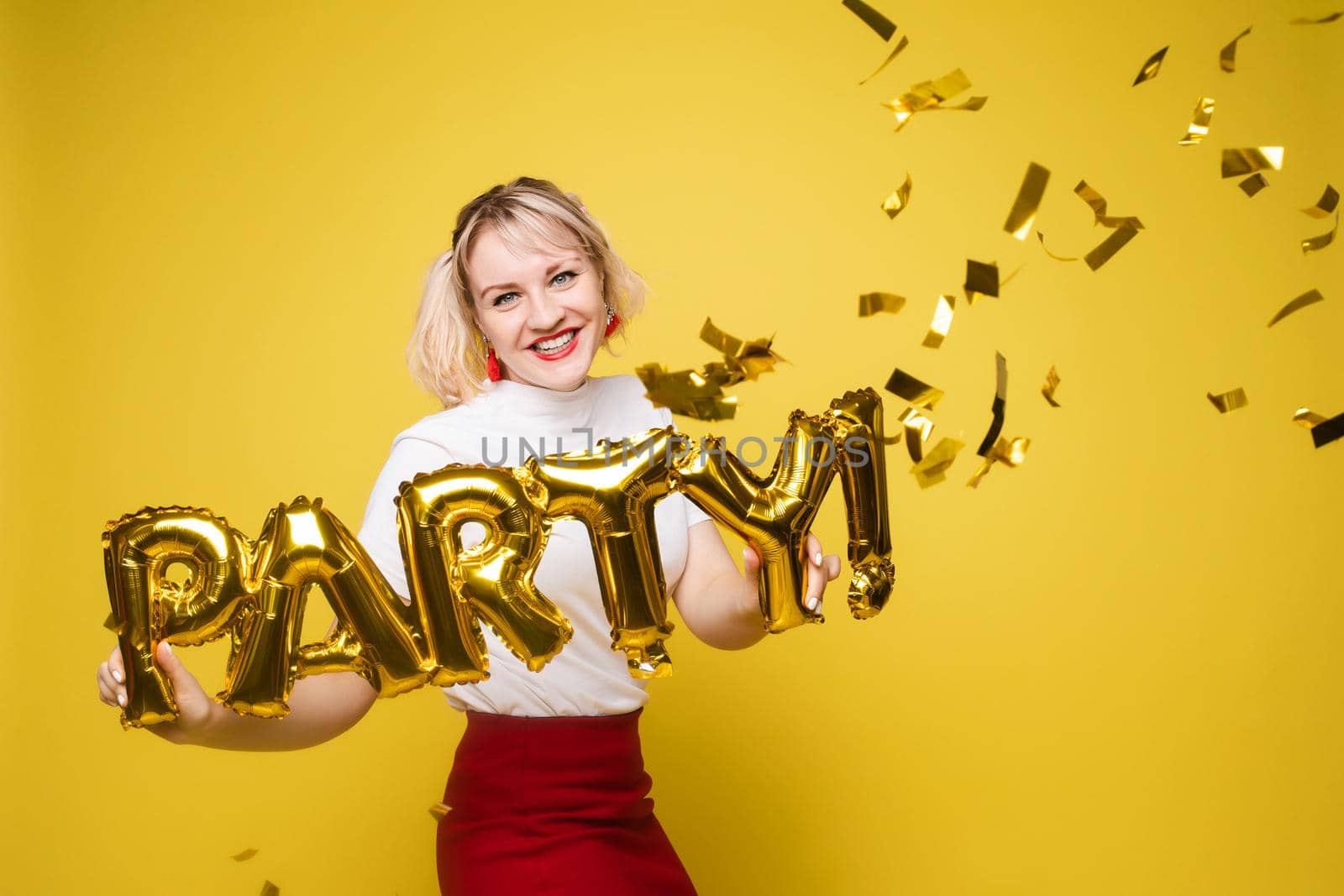 Fashionable womancelebrating a party event having fun and smiling with balloons