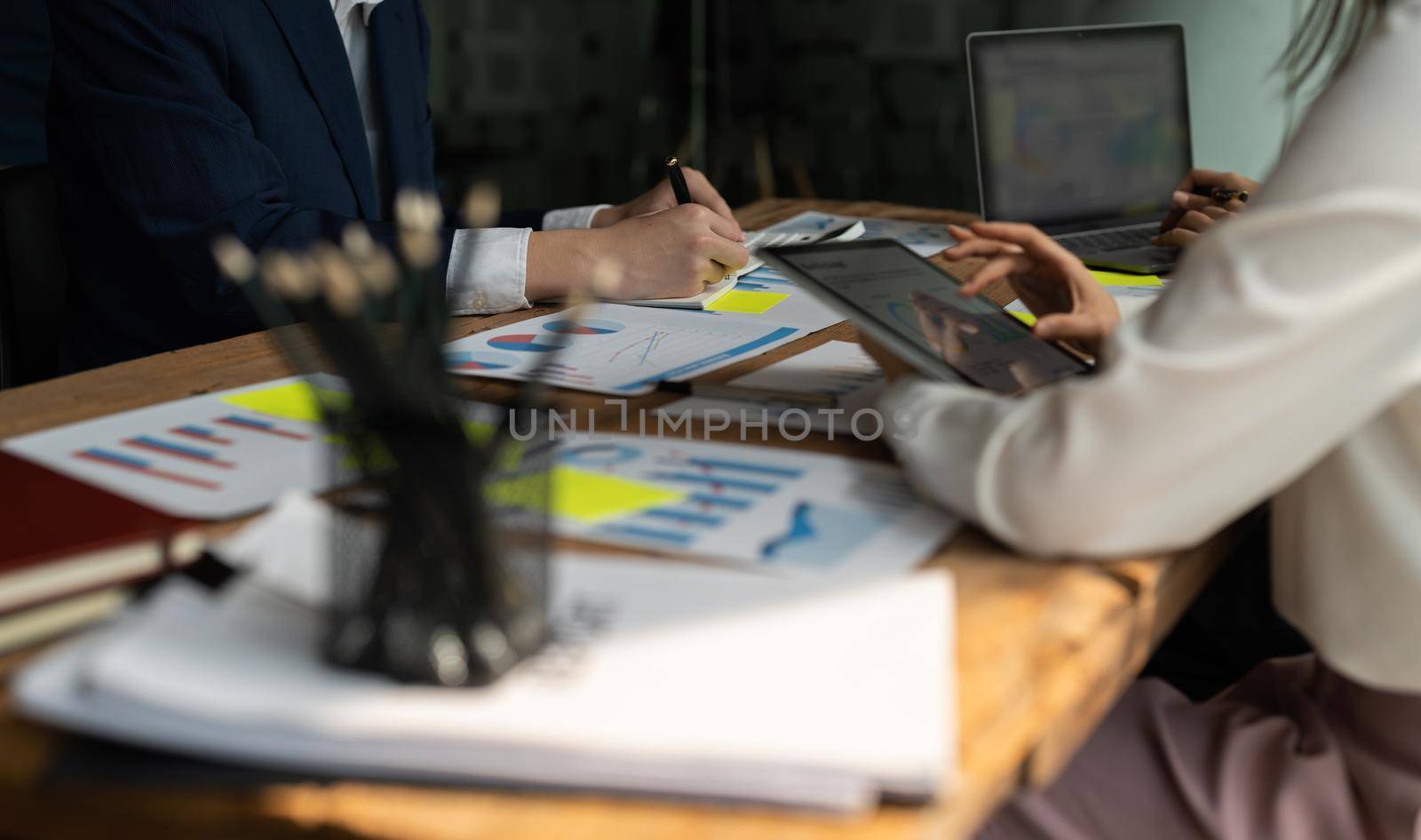 Business people analyzing investment graph meeting brainstorming and discussing plan in meeting room, investment concept.