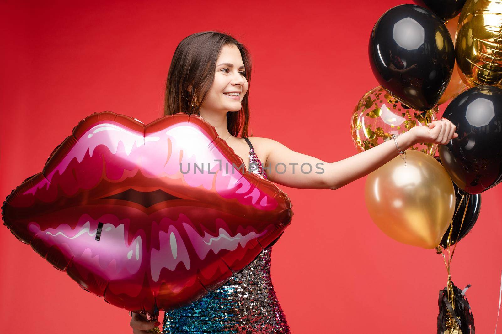 Sexy elegant brunette in beautiful sparkling dress with air balloons. by StudioLucky