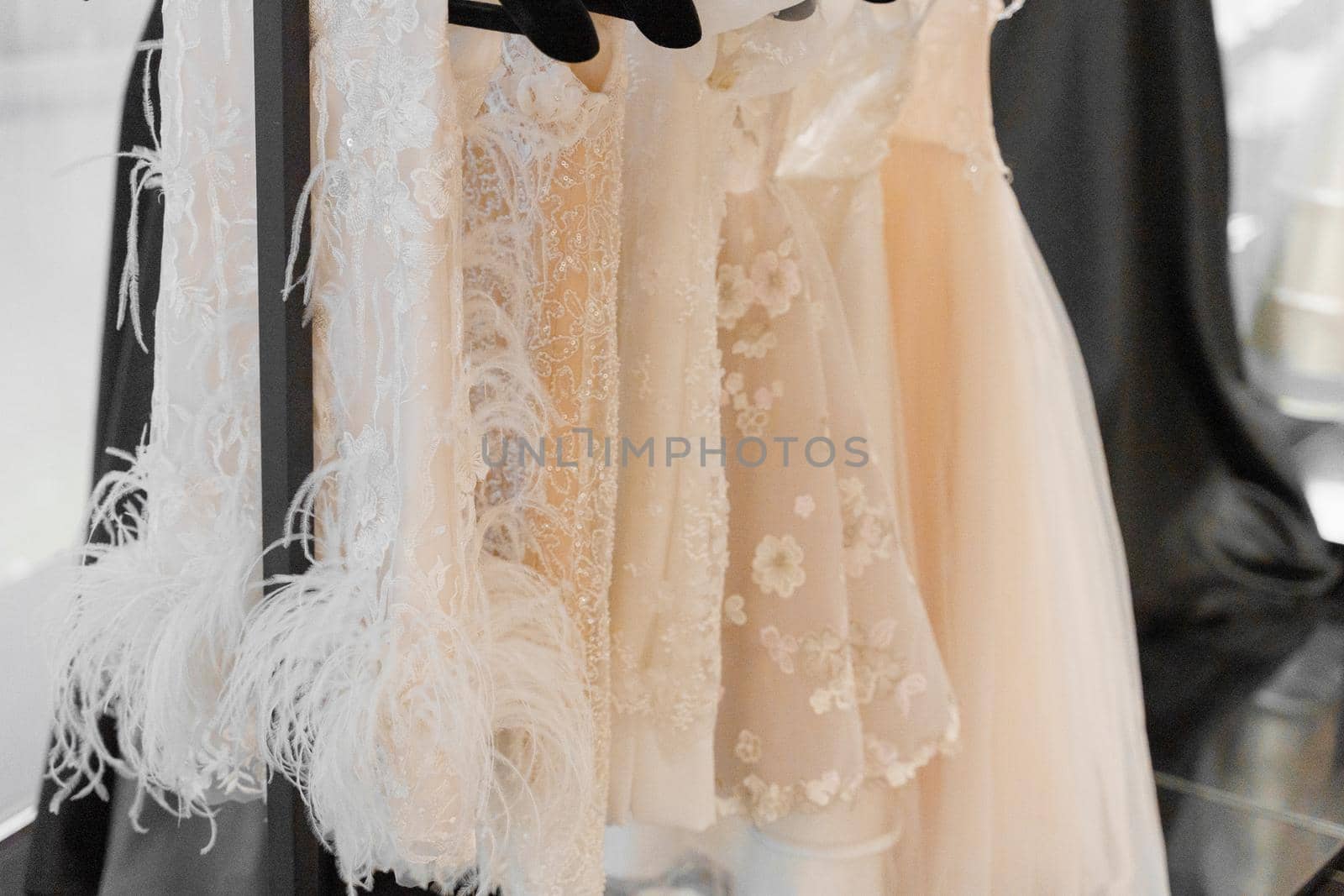 Little wedding dress for child on hangers made of silk chiffon, tulle and lace. White cream bridal dress for little princess. Pearls and crystals pendants on the sleeves of a wedding dress by Rabizo