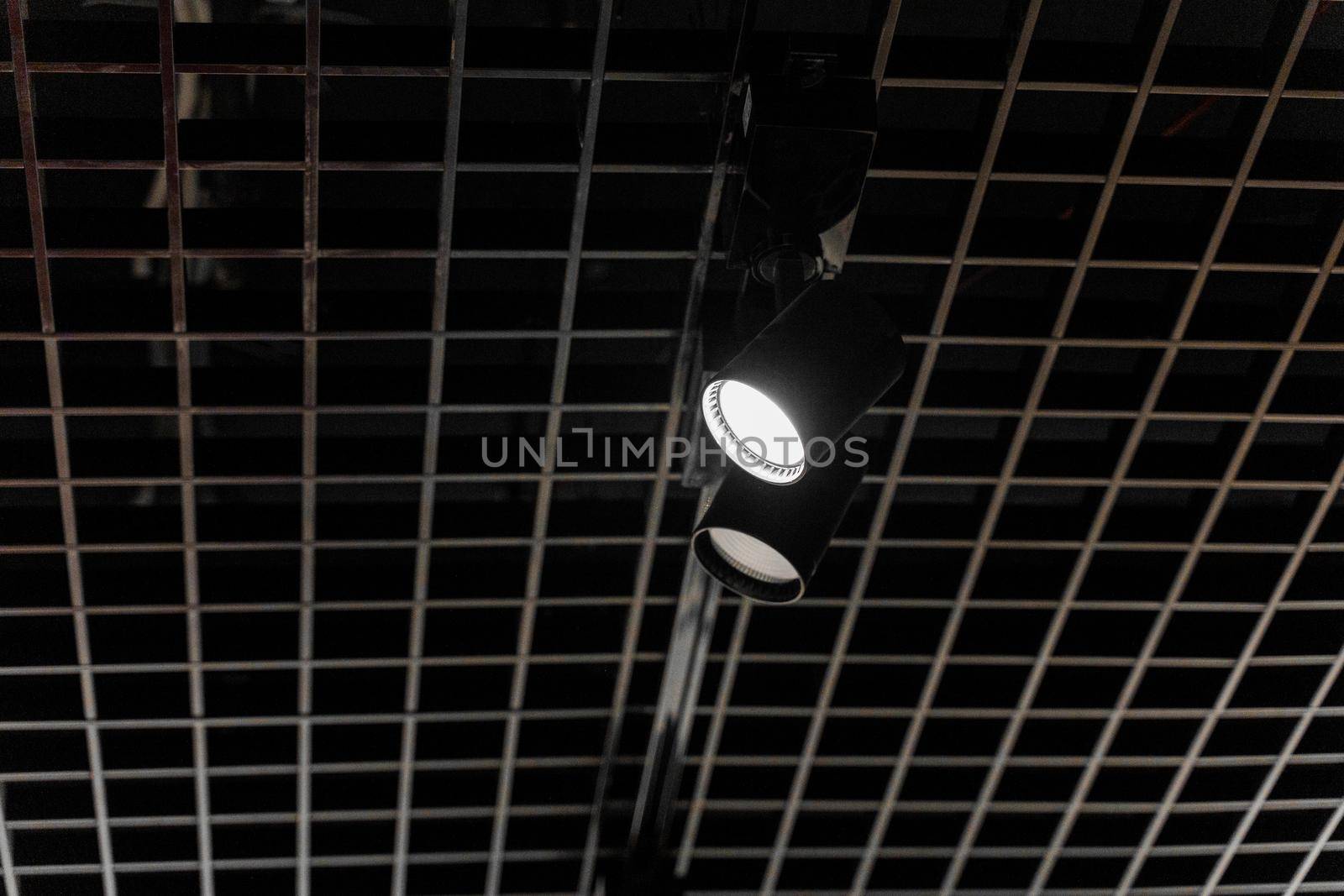 Lights system on dark ceiling of the office industrial black building, exhibition hall with led smart light. Ceiling construction
