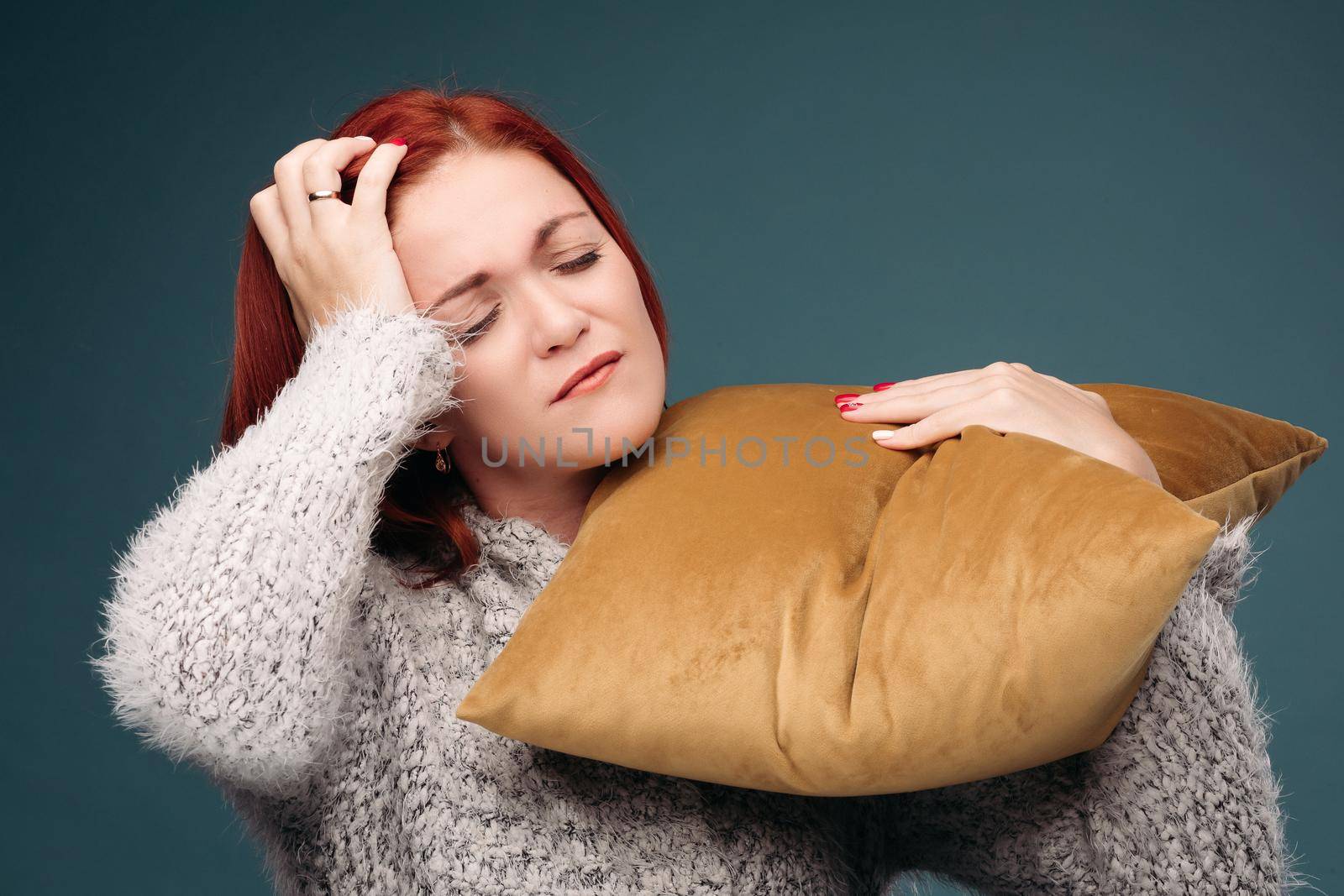 Ill woman having terrible headache and holding hand on forearm. by StudioLucky