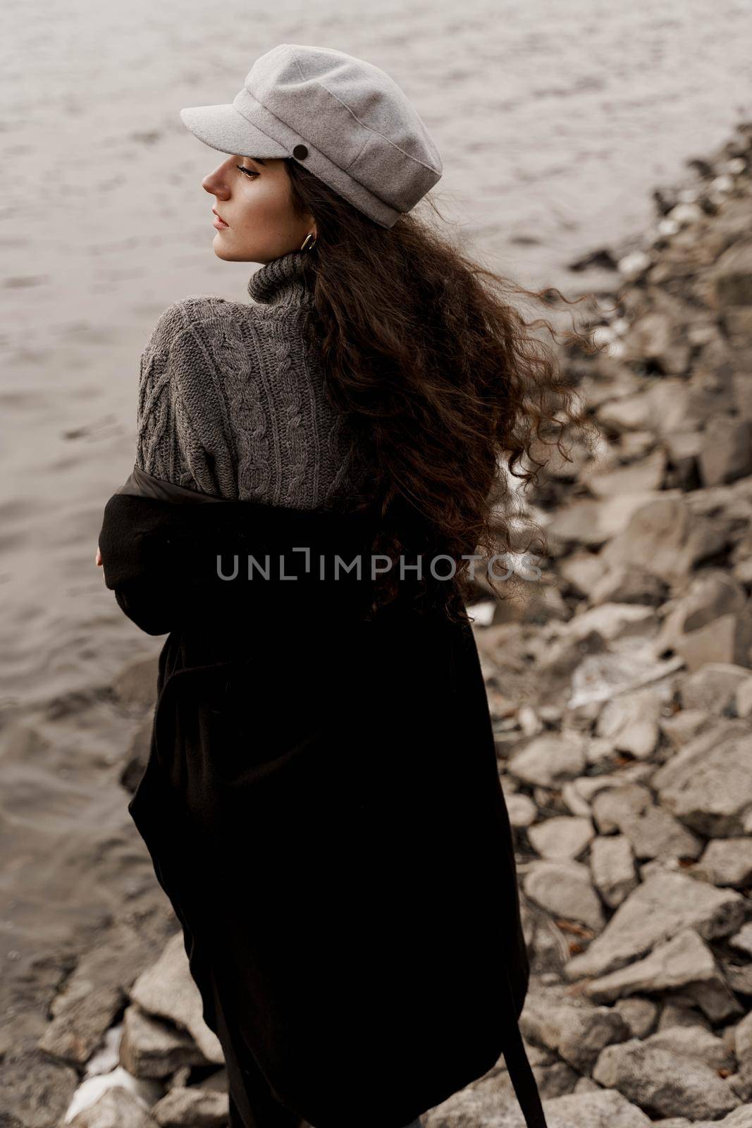 Girl with curly hair on the background of birch with stones and lake in autumn by Rabizo