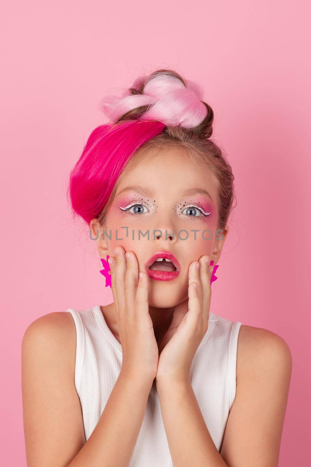 charming little girl with pink hairstyle and pink makeup. tween young model posing on pink background by oliavesna