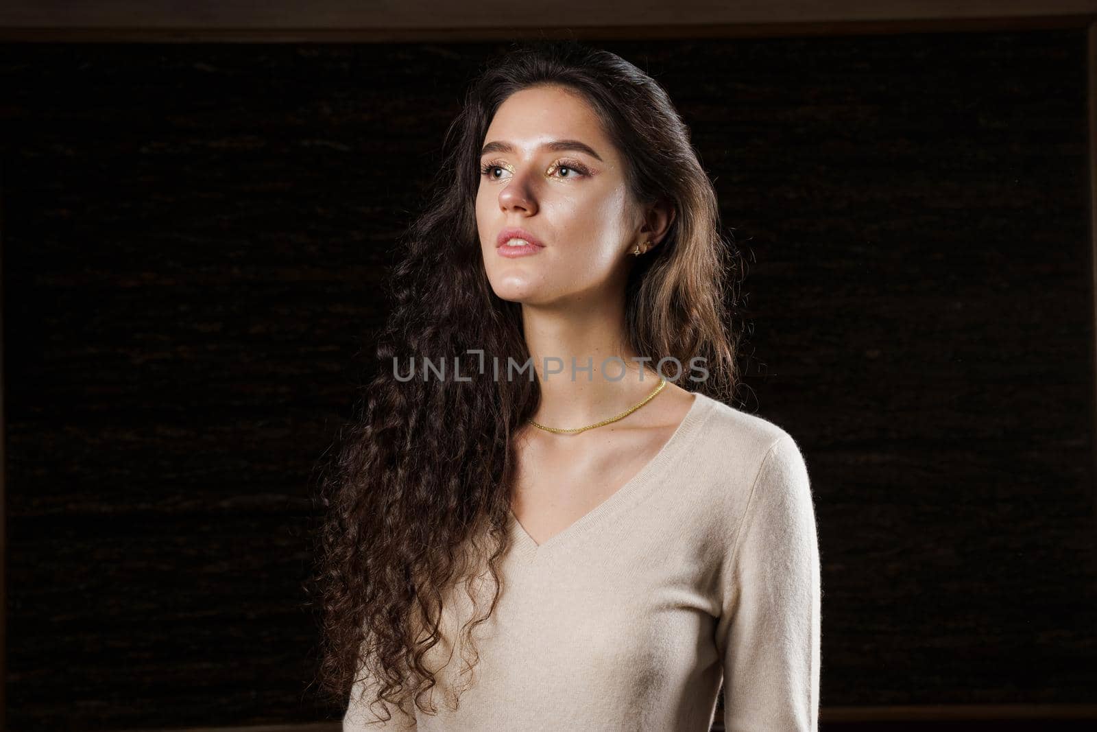 Girl dream and looking toward. Attractive young woman thinking abount love. Lifestyle of pretty girl. Happy lady weared brown pullover by Rabizo