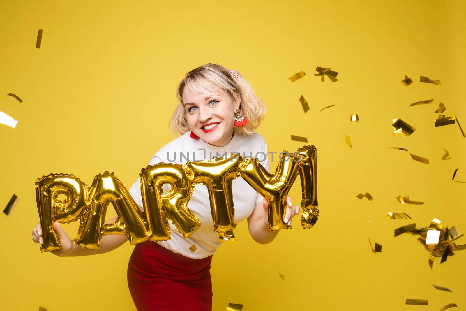 Fashionable womancelebrating a party event having fun and smiling with balloons