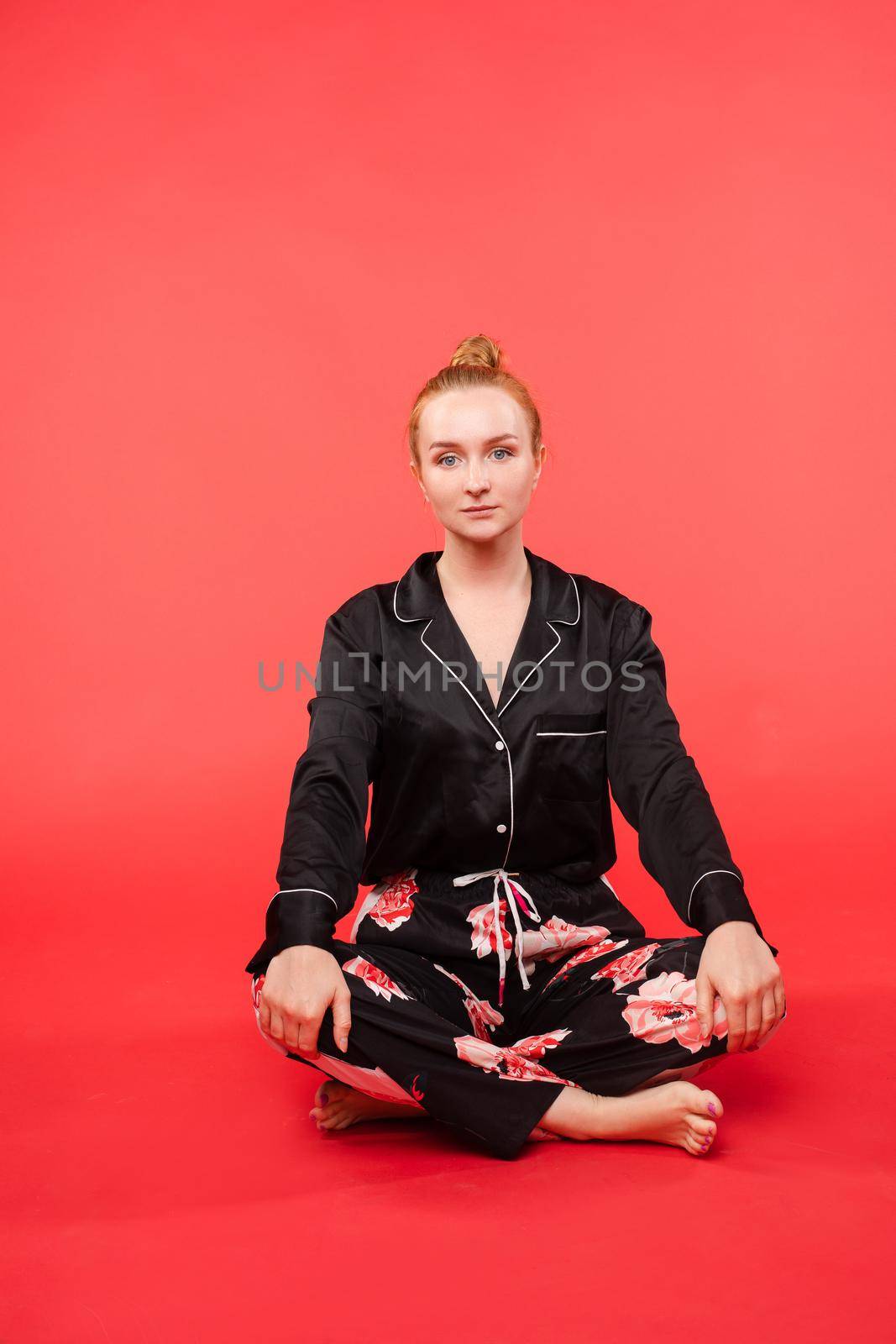 Young girl sitting on floor and meditating with closed eyes. by StudioLucky