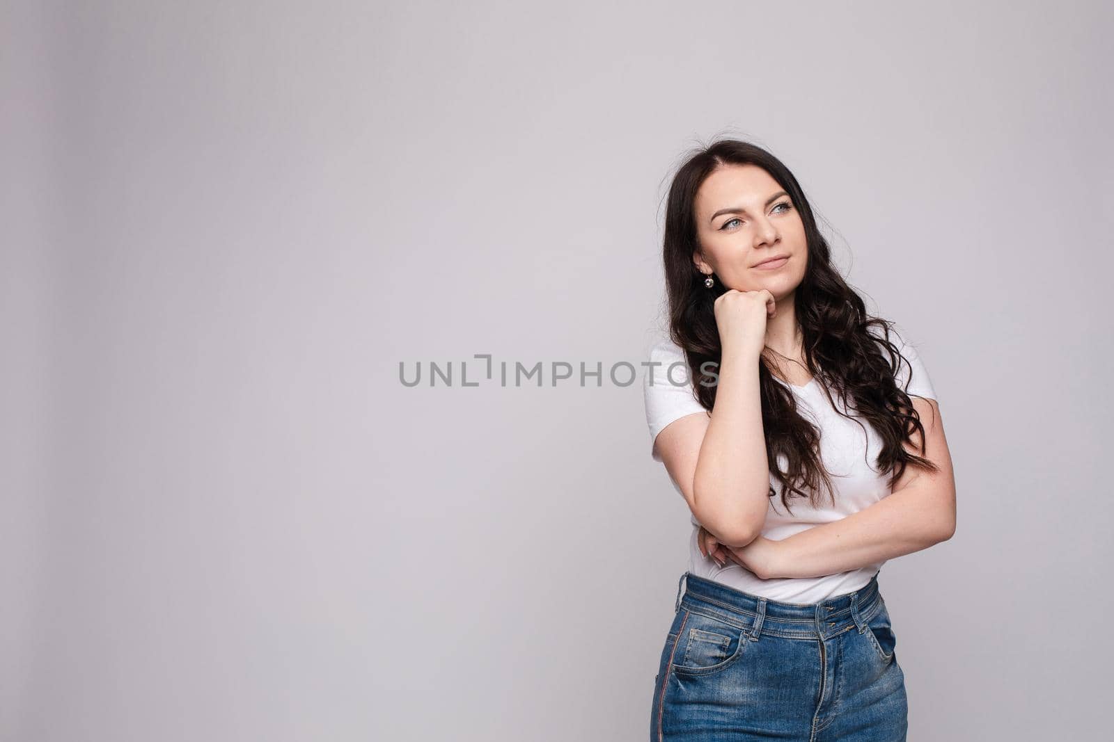 Portrait of happy fashion female with nice hairstyle and beautiful blue eyes posing at studio. Cheerful girl looking away and smiling. Isolated