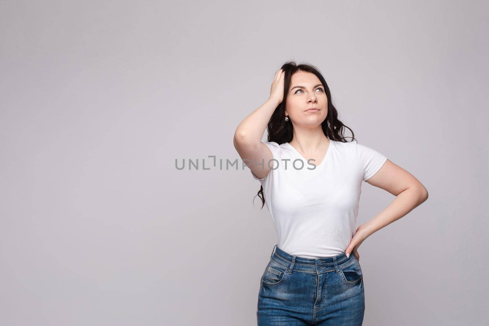 Portrait of happy fashion female with nice hairstyle and beautiful blue eyes posing at studio. Cheerful girl looking away and smiling. Isolated