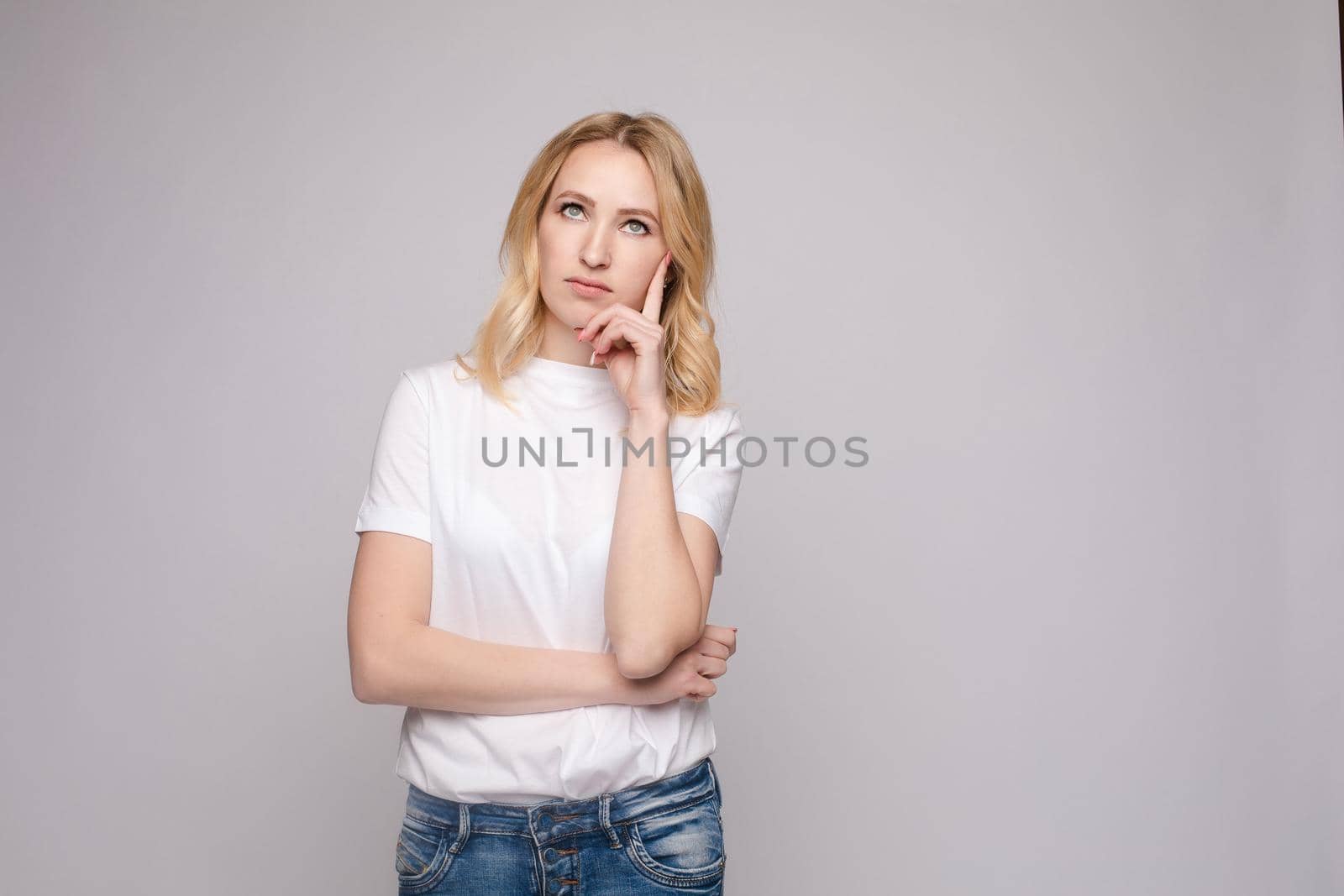 Portrait of happy fashion female with nice hairstyle and beautiful blue eyes posing at studio. Cheerful girl looking away and smiling. Isolated