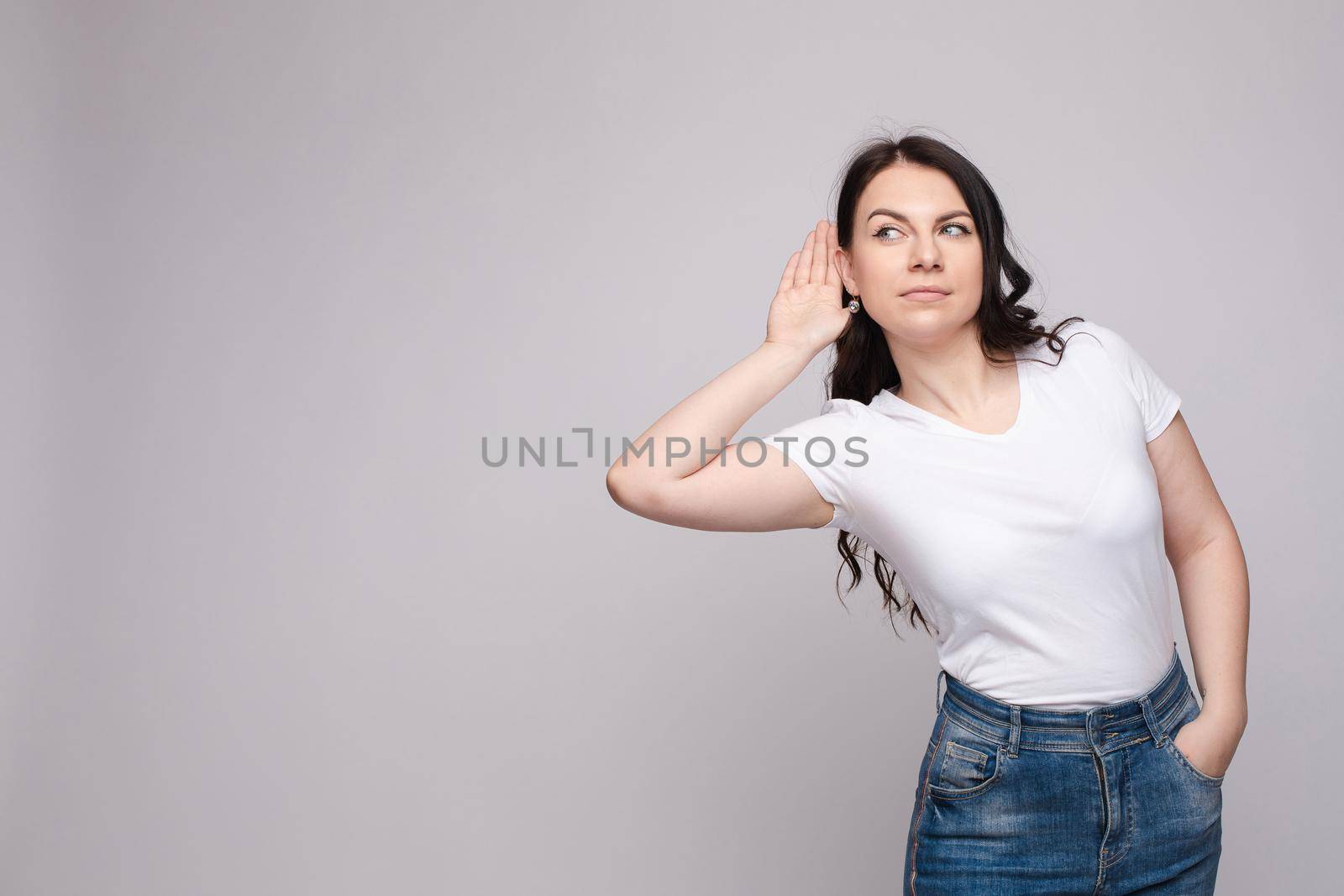 Charming girl listening to gossips. Studio portrait of beautiful caucasian by StudioLucky