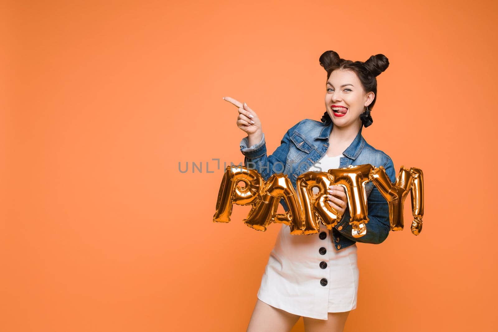 Fashionable womancelebrating a party event having fun and smiling with balloons