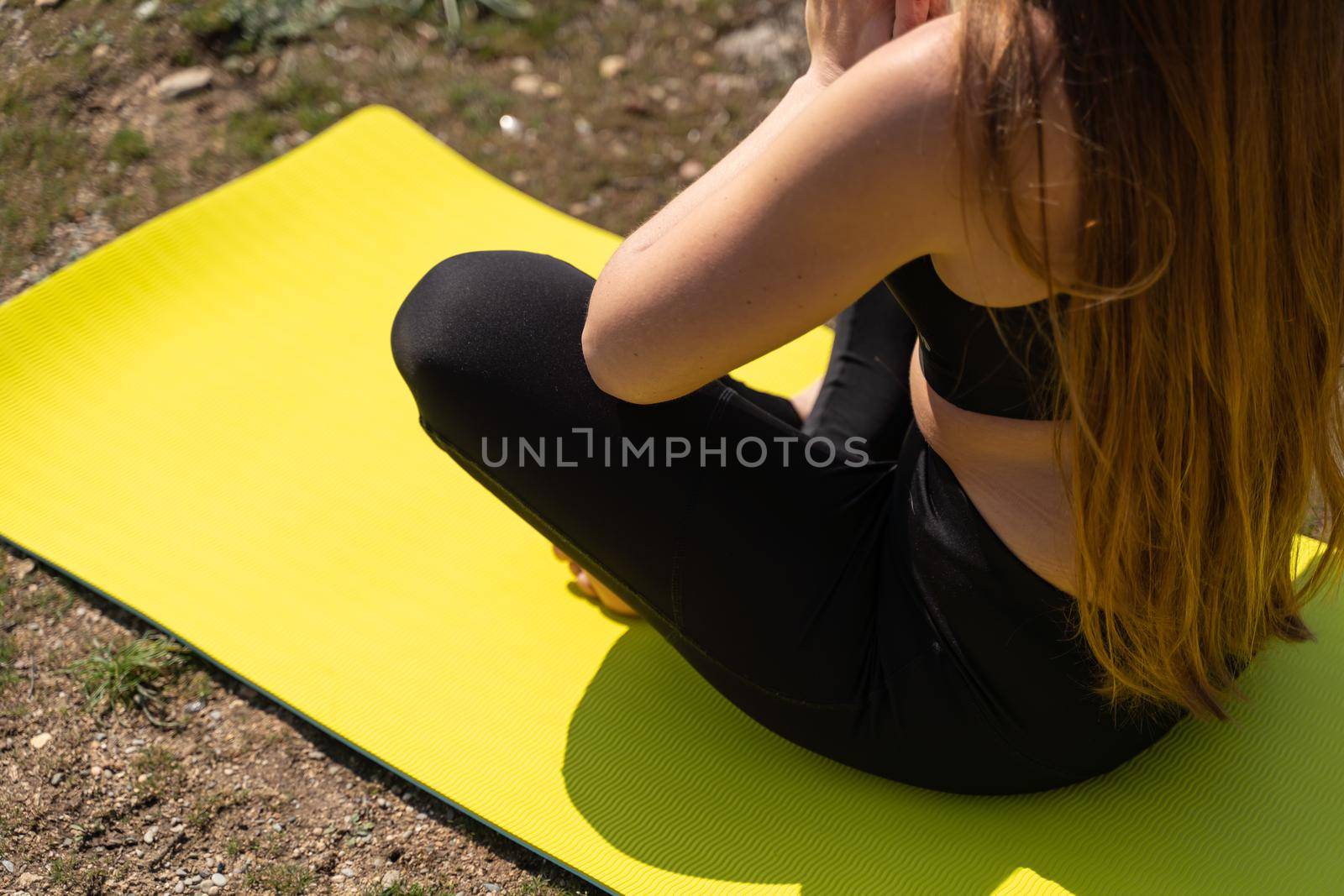 Beautiful woman practicing yoga in the park,Yoga Ardha Padmasana Half lotus pose