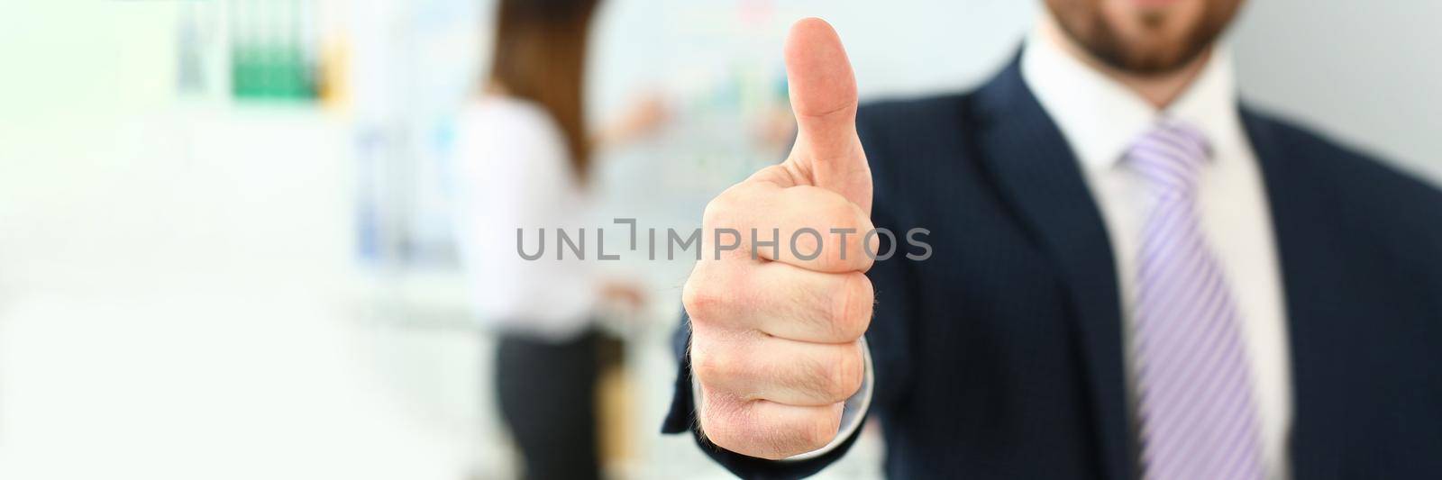 Focus on male hand performing friendly gesture towards presumptive colleague or boss in order to greet. Smart people discussing important business strategy. Company meeting concept. Blurred background