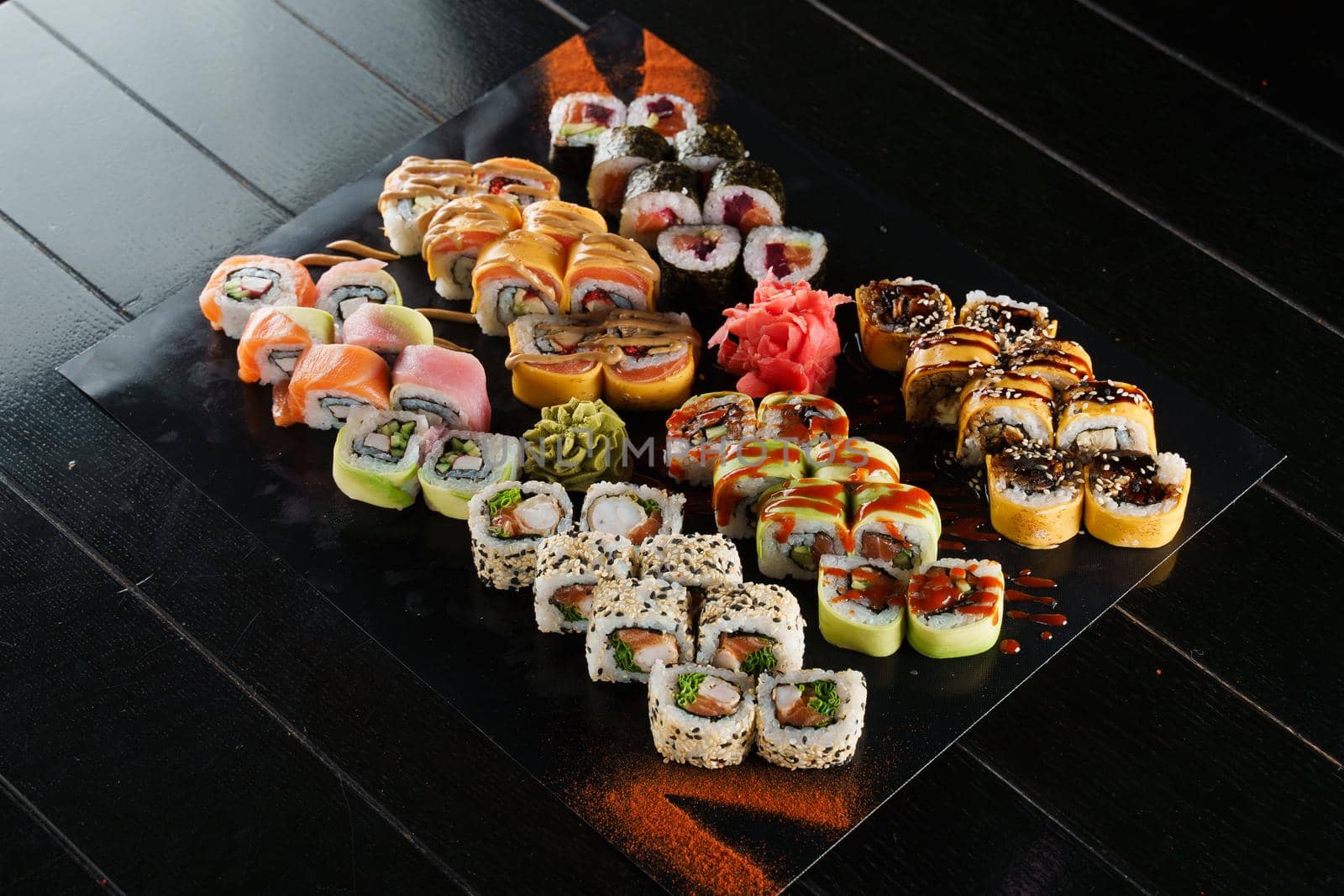 Sushi set on black background. Traditional Japanese seafood. Delicious roll. Advert for food delivery service. by Rabizo