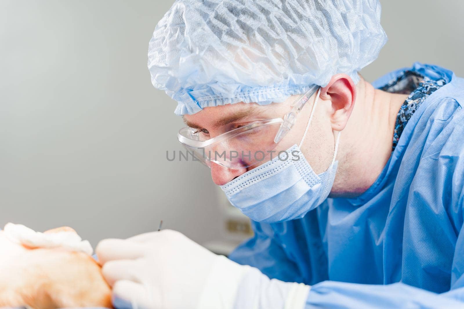 Surgeons do plastic operation in medical clinic. Surgery. Professional medecine. Skin care. Correcting form of face for patient