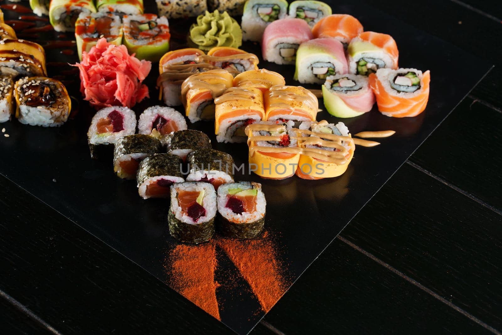 Sushi set on black background. Traditional Japanese seafood. Delicious roll. Advert for food delivery service. by Rabizo