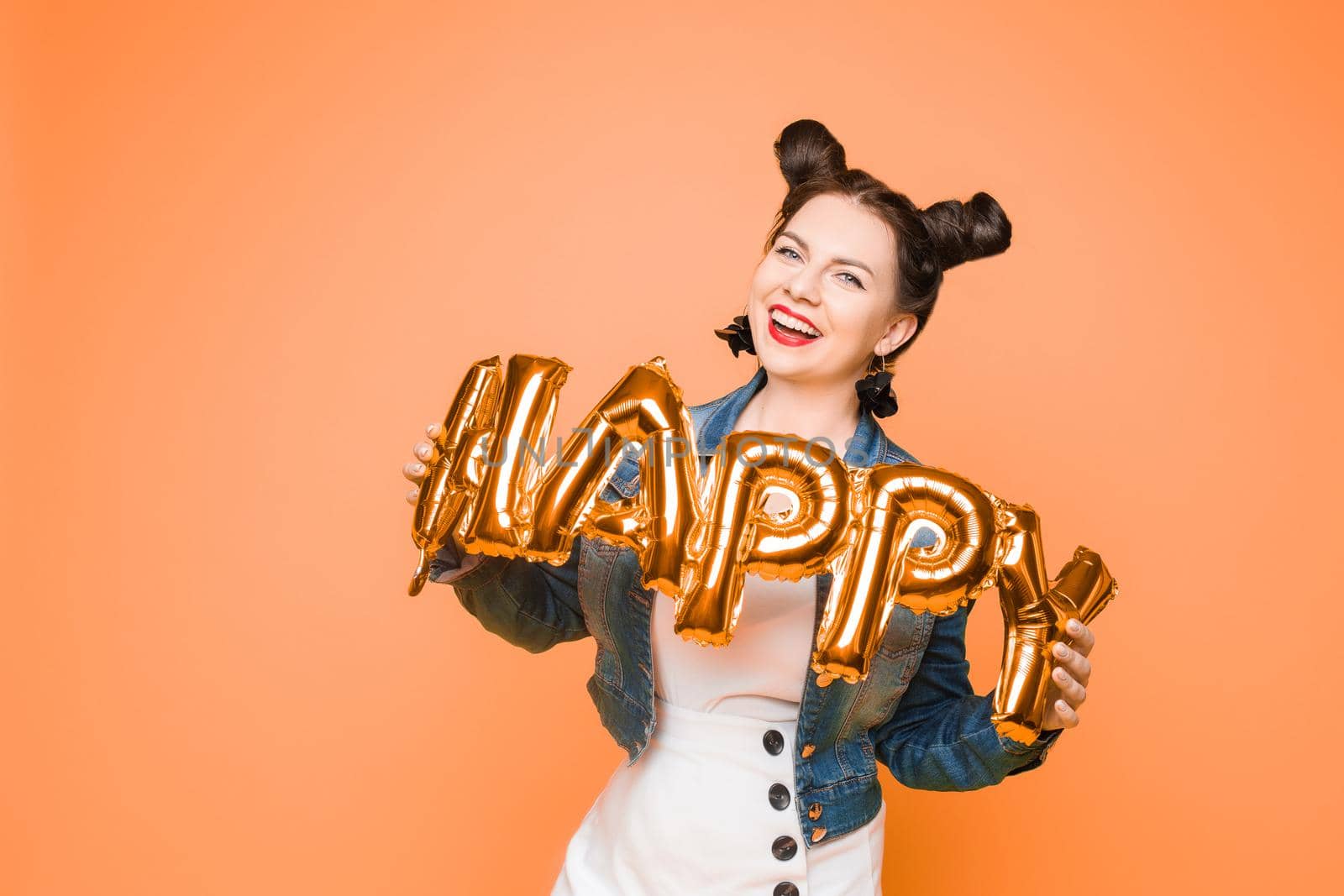 Fashionable womancelebrating a party event having fun and smiling with balloons