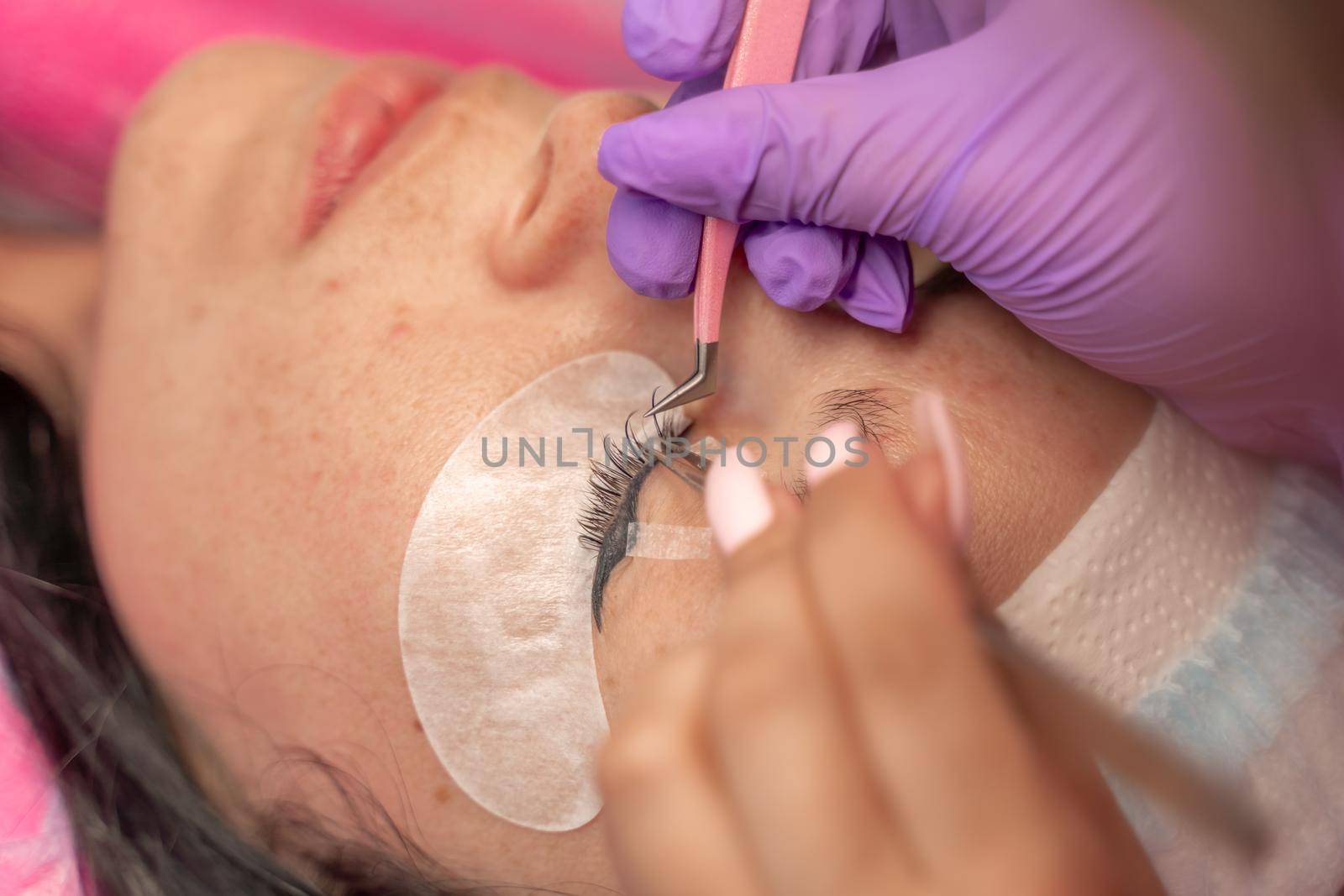 Eyelash extension procedure. Woman eye with long eyelashes. lashes, close up, macro, selective focus. by Matiunina