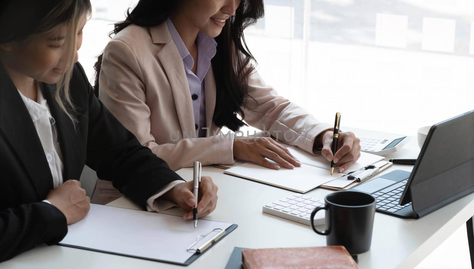 Young Asian businesswoman work together to analysis from work at the office..