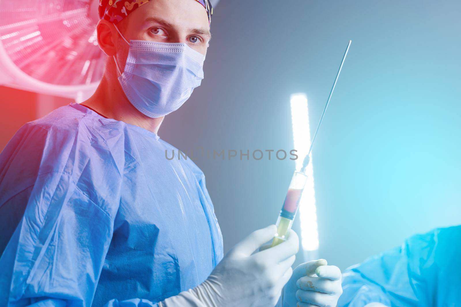 Surgeon holding syringe with humans fat. Liposuction for lipofilling surgery operation. Plastic operation in medical clinic