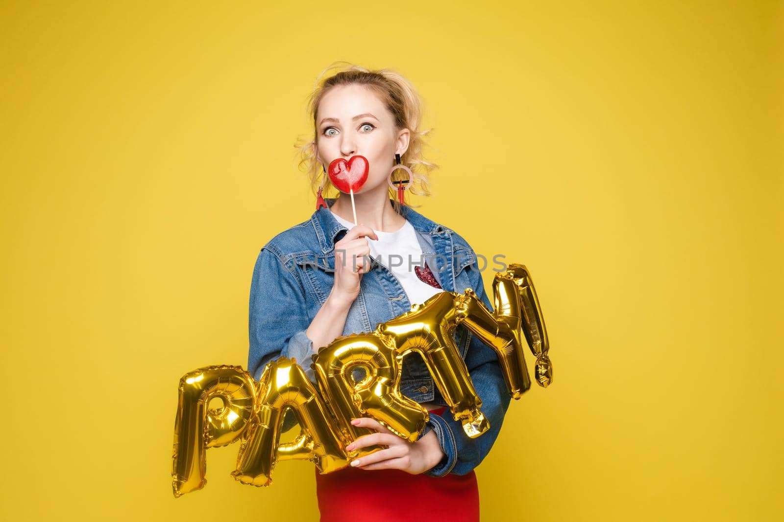 Fashionable womancelebrating a party event having fun and smiling with balloons