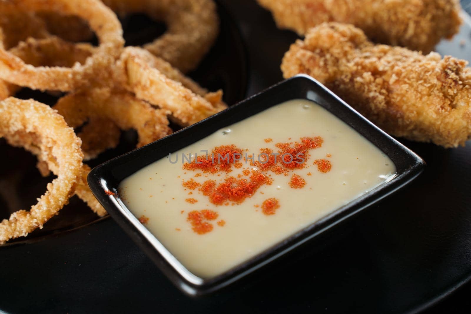 Beer snacks. Breaded meat appetizer and onion rings.