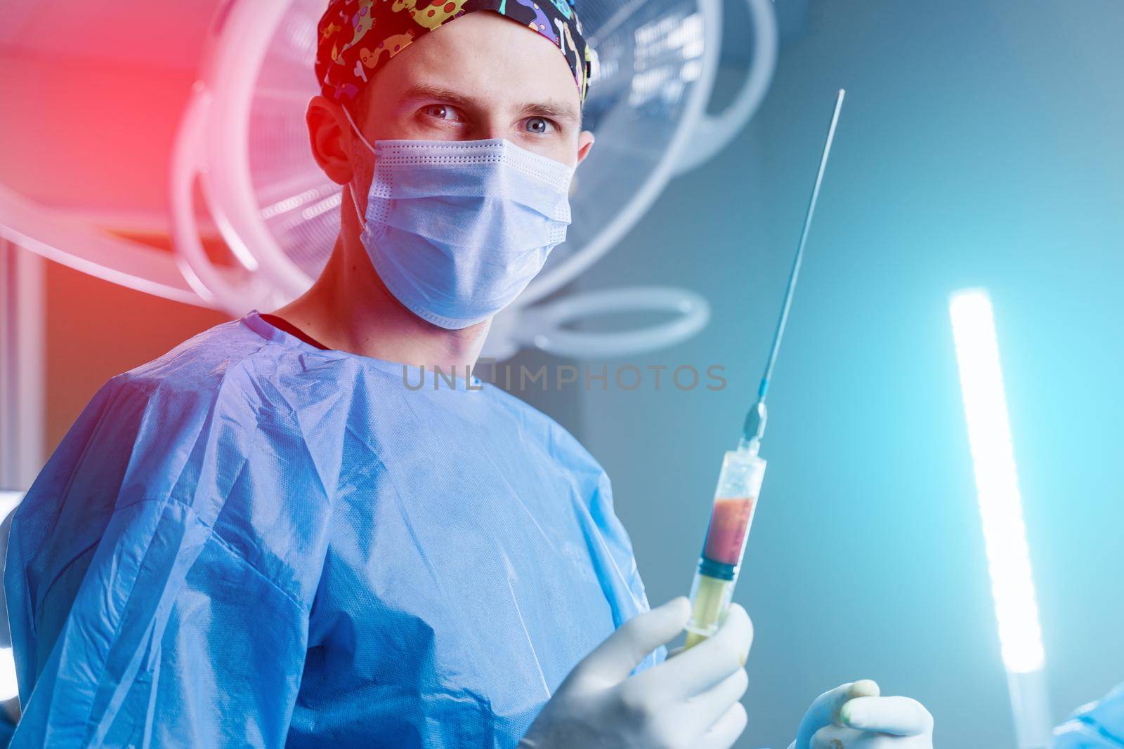 Surgeon holding syringe with humans fat. Liposuction for lipofilling surgery operation. Plastic operation in medical clinic