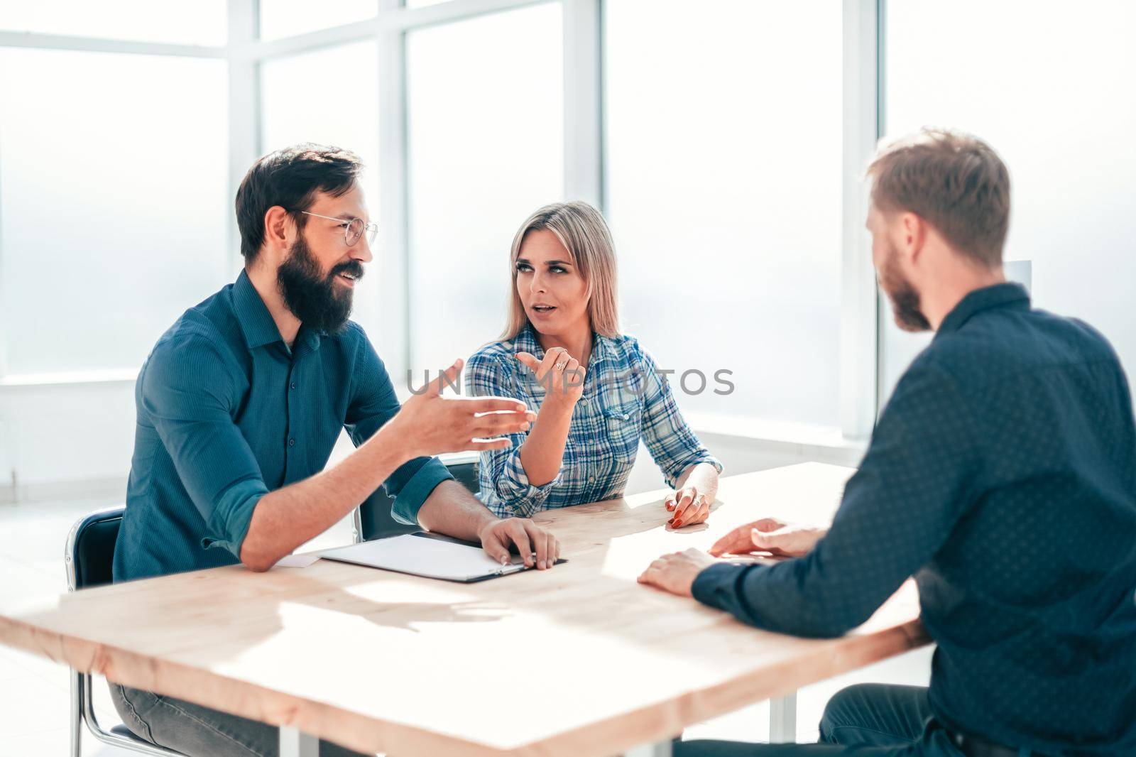 managers and job seeker sitting at the table during the interview by SmartPhotoLab
