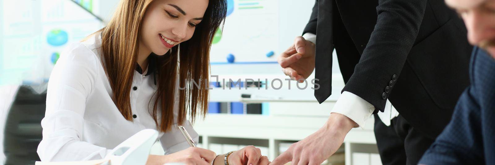Portrait of attractive business partner discussing conditions of complicated contract. Corporate man pointing at something and explaining every detail of agreement. Company meeting concept