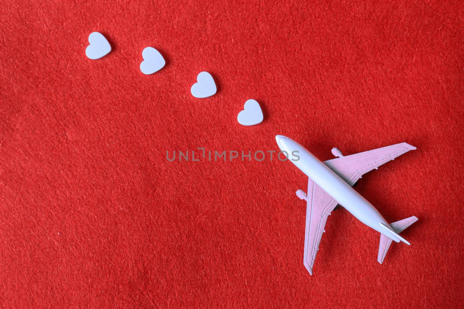 Hearts and a plane on a red background. Valentine's Day. Selective focus. Valentine.