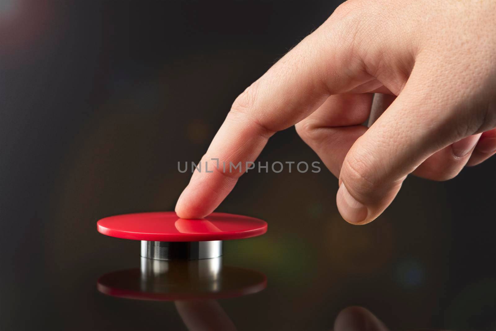 The hand presses the big red button. The concept of the threat of nuclear war. A threat to the world with a nuclear suitcase and a bomb. The hand presses the rocket launch button. by SERSOL