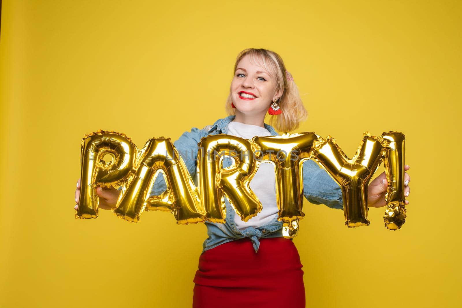 Fashionable womancelebrating a party event having fun and smiling with balloons