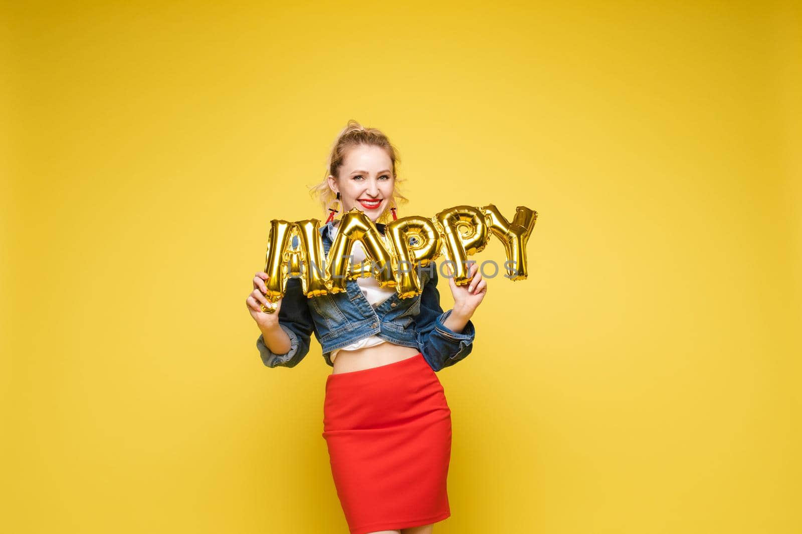 Fashionable womancelebrating a party event having fun and smiling with balloons